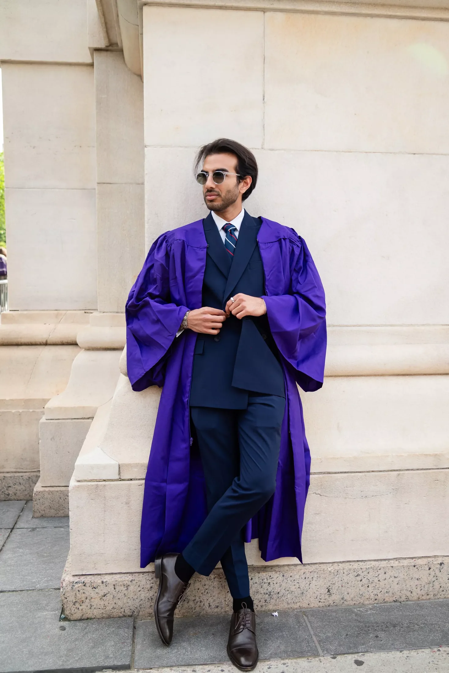 Kiyan in his purple NYU graduation gown